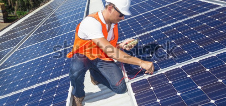 worker installing solar panels